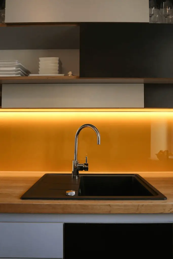 Kitchen sink with under-the-cabinet LED strip